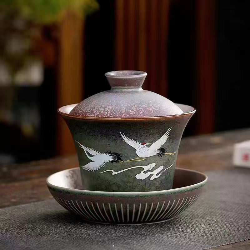 A kiln-formed cranes and celestial cranes teapot in rough earthenware Vintage teapot