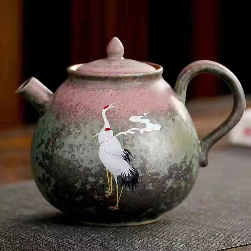 A kiln-formed cranes and celestial cranes teapot in rough earthenware Vintage teapot