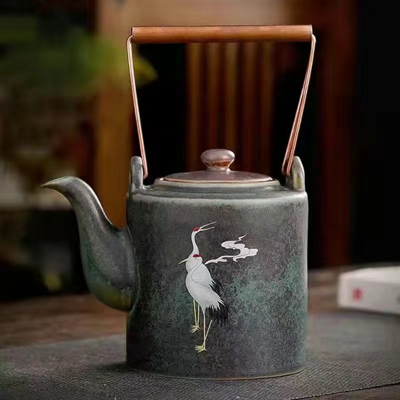 A kiln-formed cranes and celestial cranes teapot in rough earthenware Vintage teapot