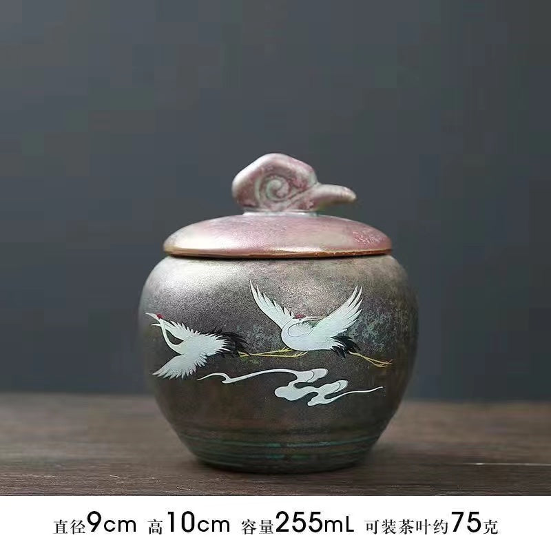 A kiln-formed crane tea jar