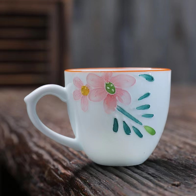 A bird and flower cup and a jug and a jug of water