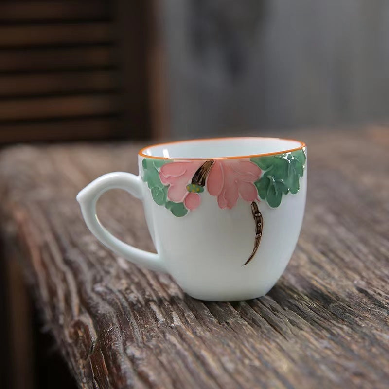 A bird and flower cup and a jug and a jug of water