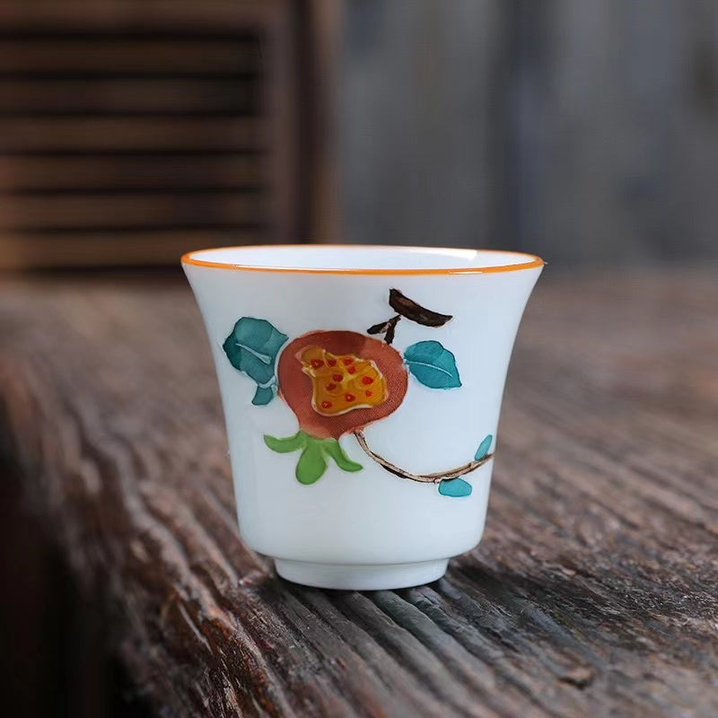 A bird and flower cup and a jug and a jug of water