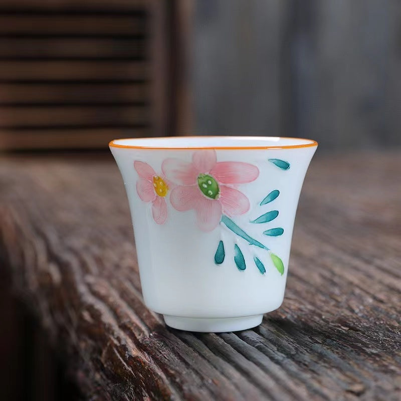 A bird and flower cup and a jug and a jug of water