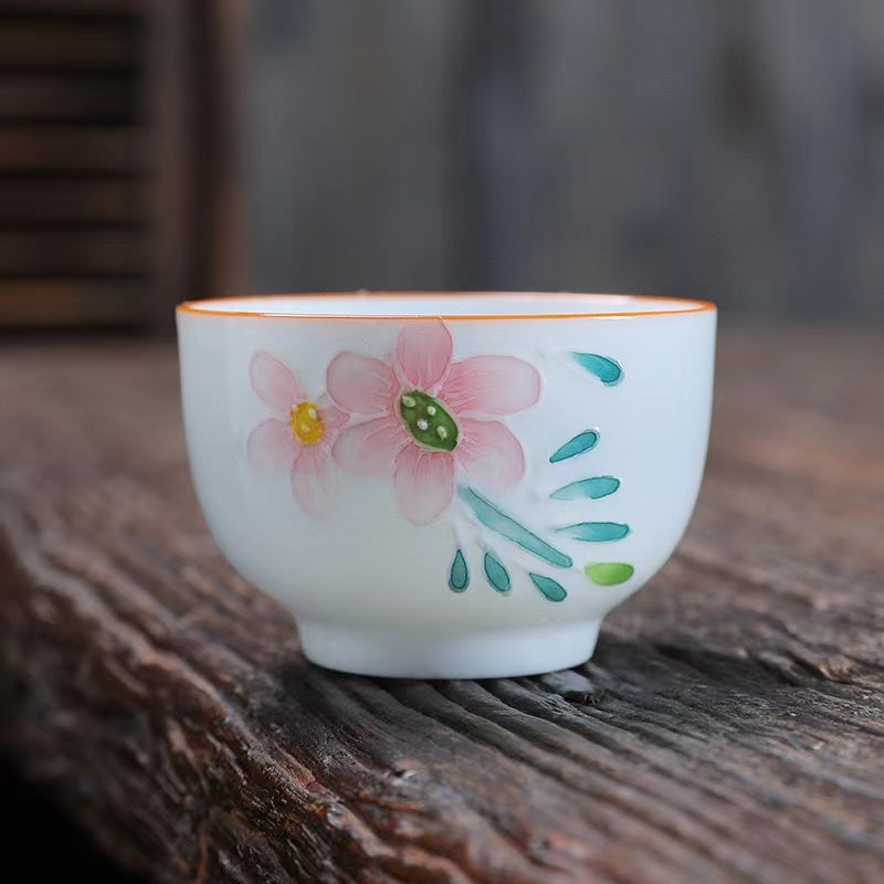 A bird and flower cup and a jug and a jug of water