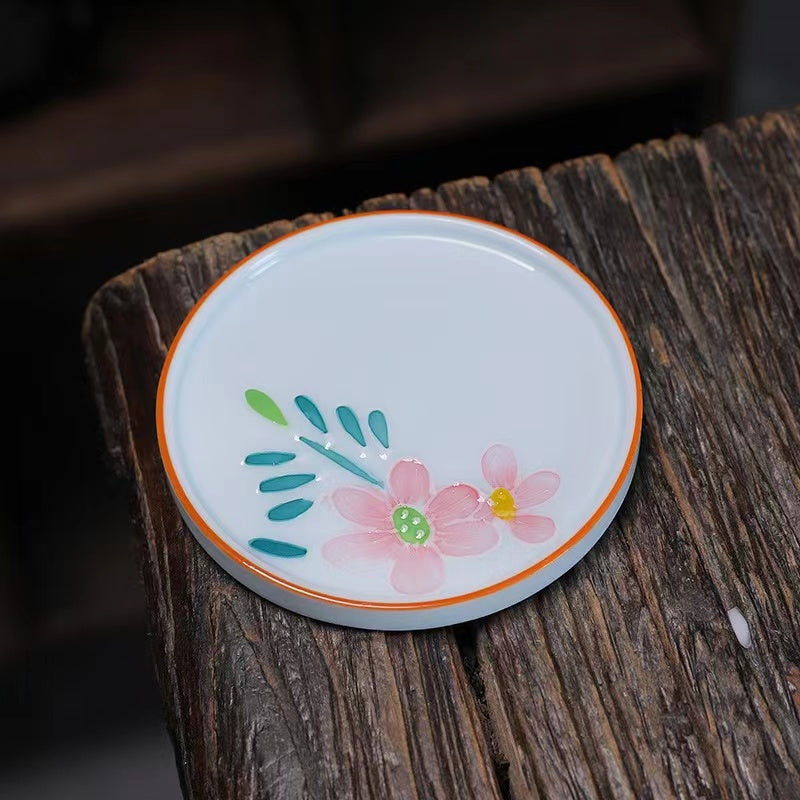 A bird and flower cup and a jug and a jug of water