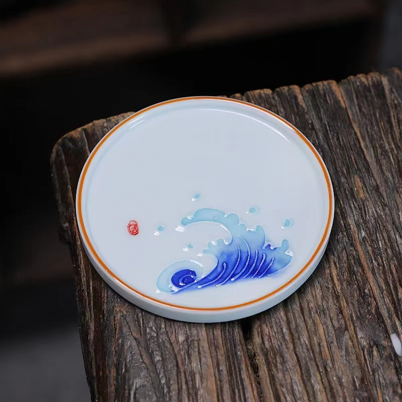 A bird and flower cup and a jug and a jug of water