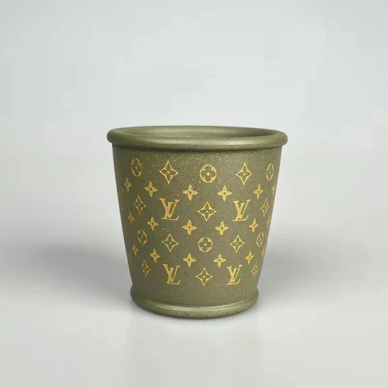 Hand-made teacup with carved and traced gold pattern in purple sand