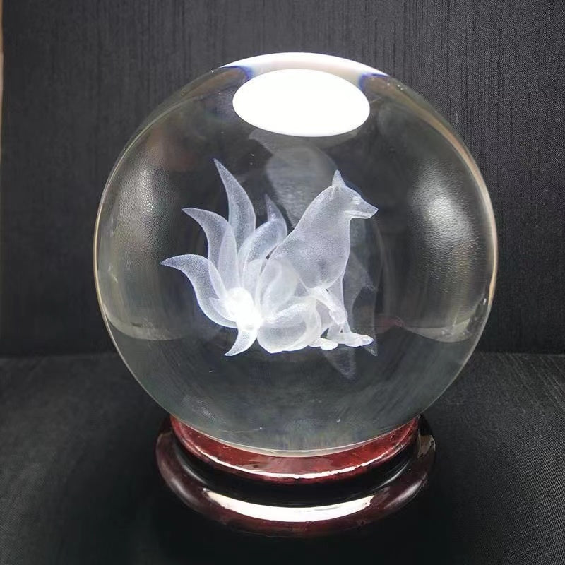 A white crystal ball with a carved nine-tailed fox inside