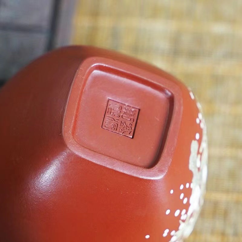 A hand-painted purple sand teacup in the original clay Da Hong Pao