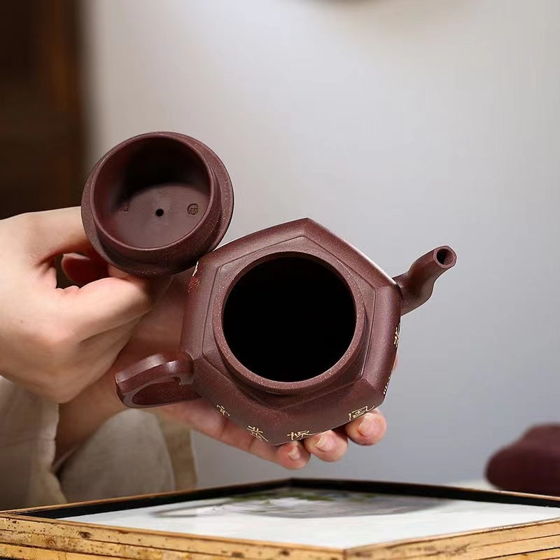 A handmade orchid palace lamp teapot in Yixing purple clay