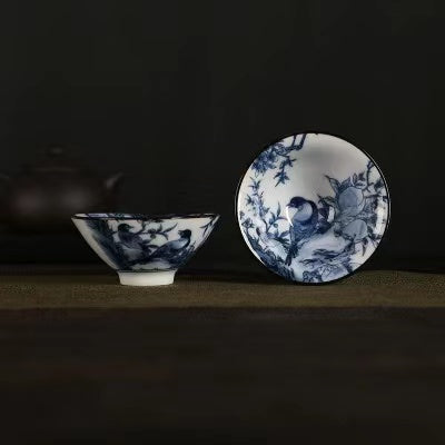 A blue and white porcelain tea cup with bucket cup