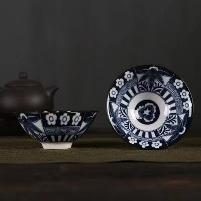 A blue and white porcelain tea cup with bucket cup