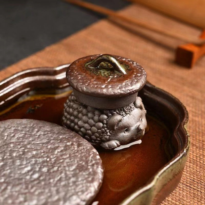 Roughly fired earthenware tea pet tea tray in clear water and wood