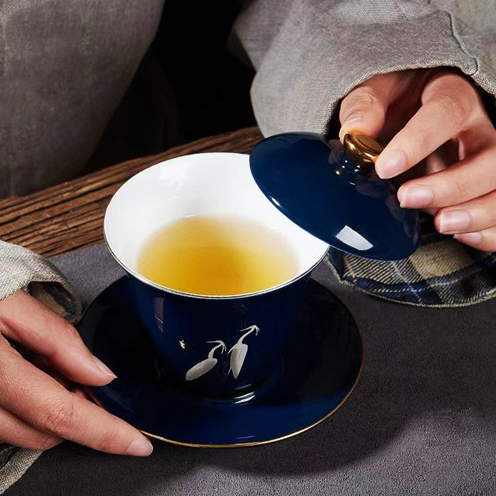 White Heron Covered Bowl with Gold Painting on Blue Background