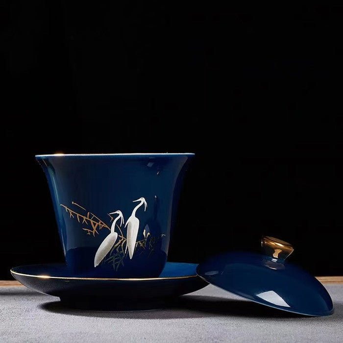 White Heron Covered Bowl with Gold Painting on Blue Background