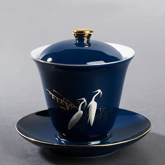 White Heron Covered Bowl with Gold Painting on Blue Background
