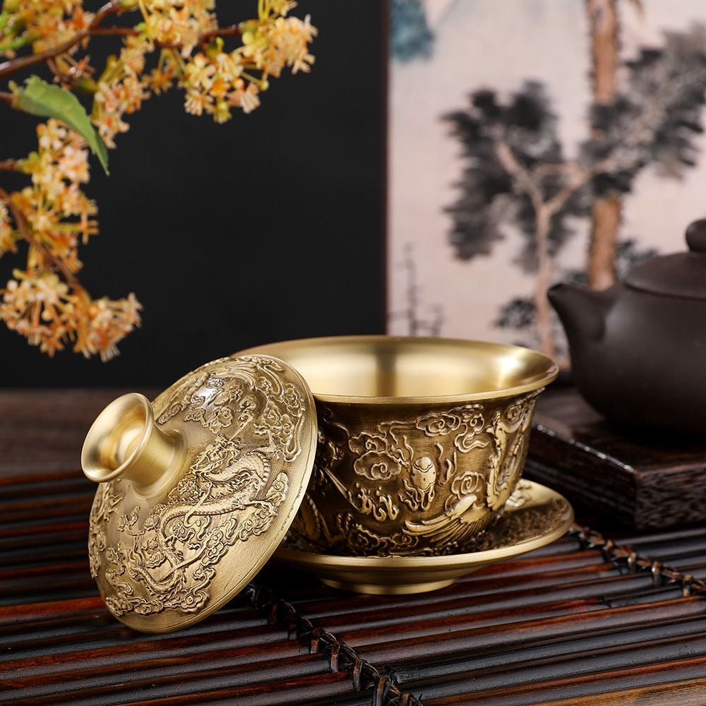 A brass dragon and phoenix covered bowl