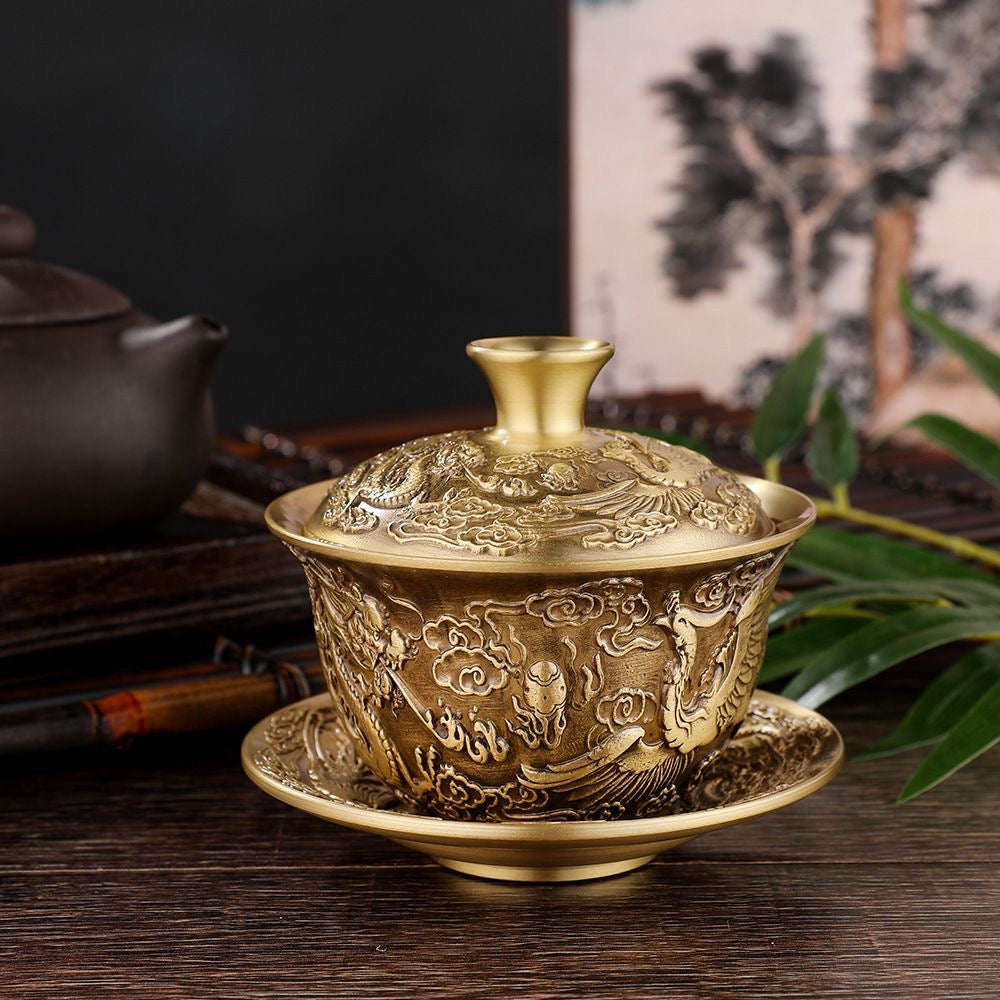 A brass dragon and phoenix covered bowl