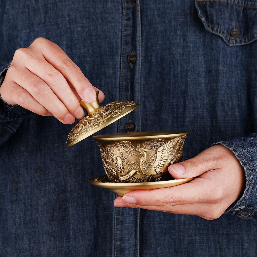 A brass dragon and phoenix covered bowl